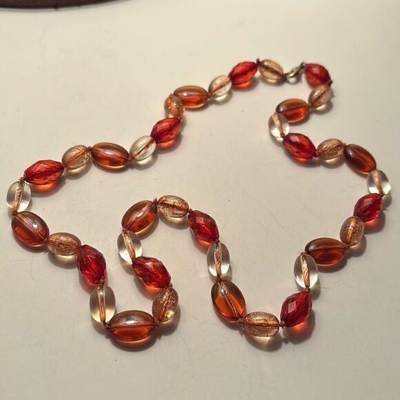 Long beaded necklace with clear and burnt orange plastic beads - Picture 1 of 3